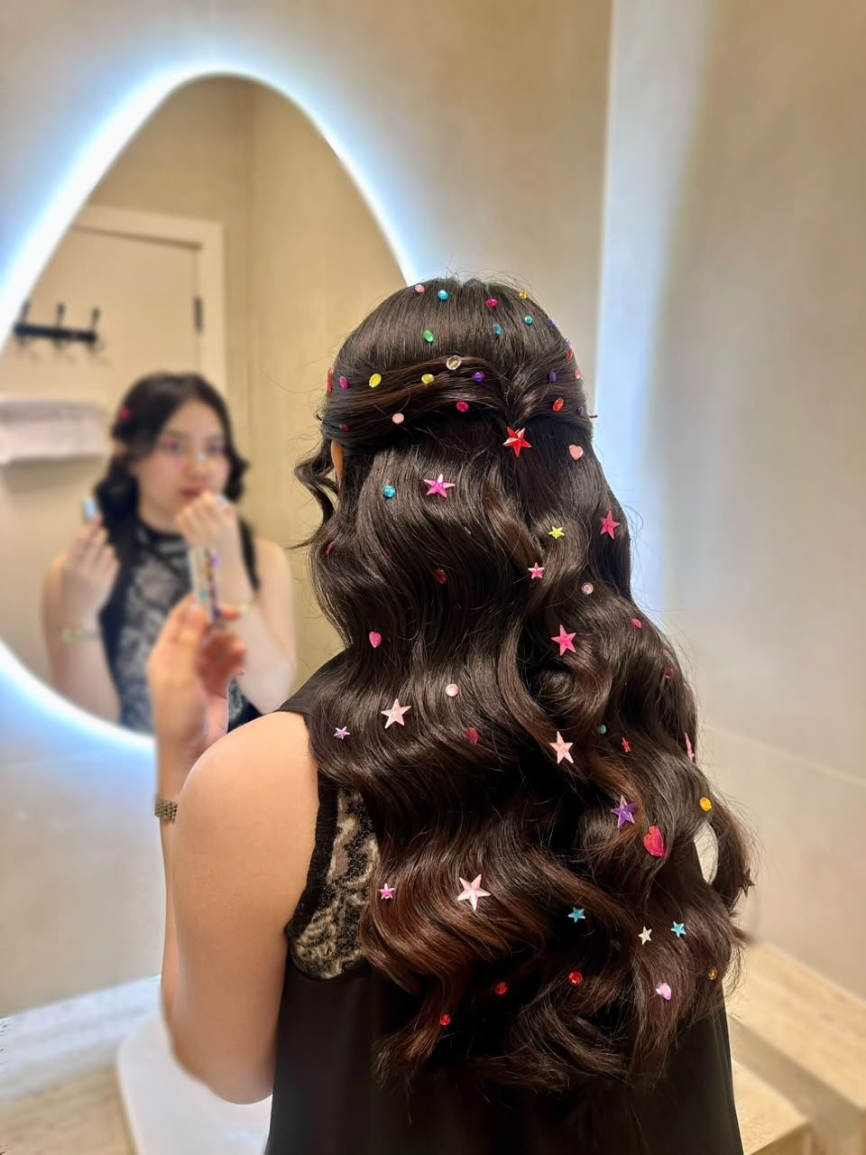 Long waves styled with colorful star clips at Weneya